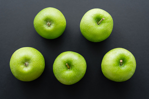 flat lay of fresh and green apples on black