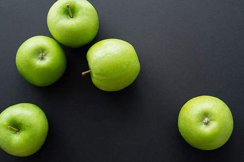 top view of ripe and green apples on black