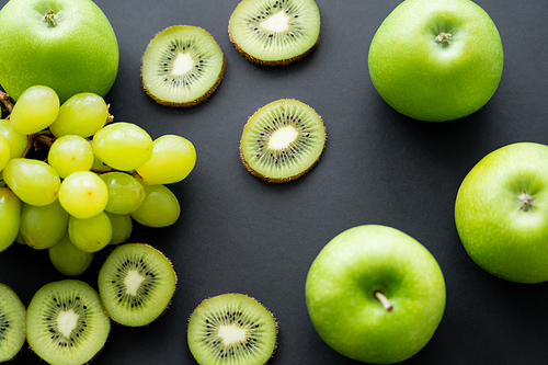 top view of green apples near ripe fruits on black