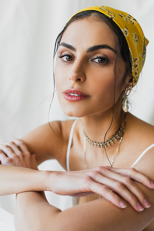 trendy woman in yellow headscarf and crop top  on white
