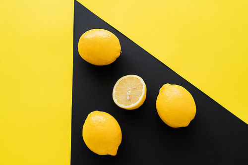 Top view of lemons on black and yellow background