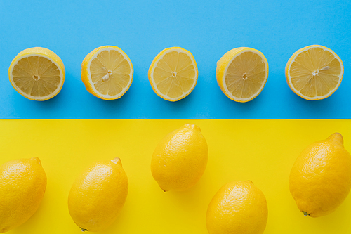 Flat lay with lemons on blue and yellow background
