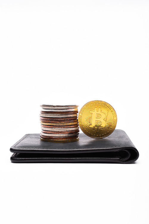 KYIV, UKRAINE - APRIL 26, 2022: Close up view of different bitcoins on wallet on white background