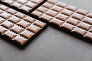 Close up view of natural chocolate bars on black surface