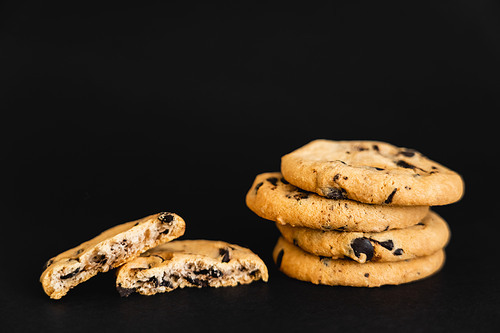 Close up view of cookies with chocolate chips on black background