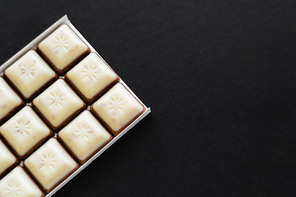Top view of white chocolate on black surface