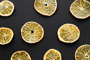 Top view of dry orange slices on black background