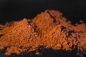 Close up view of dry cocoa powder on black background