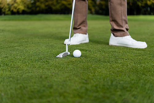 cropped view of blurred man playing golf