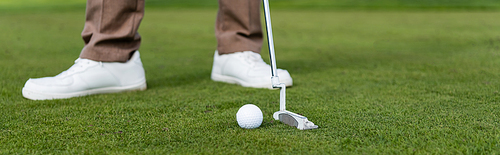 cropped view of blurred man playing golf, banner