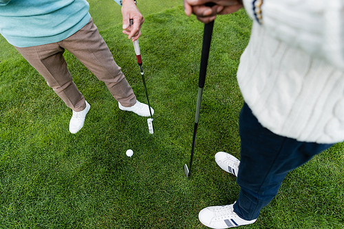 high angle view of senior men standing with golf clubs