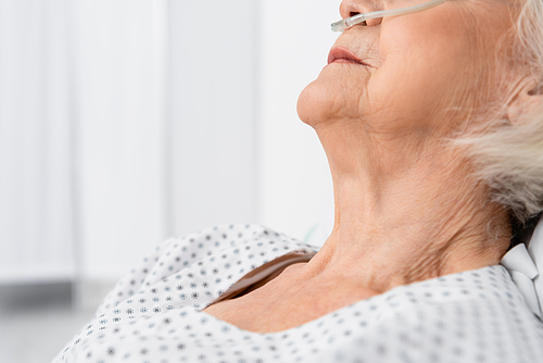 Cropped view of senior patient with nasal cannula in hospital ward