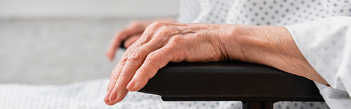 Cropped view of elderly woman sitting in wheelchair, banner