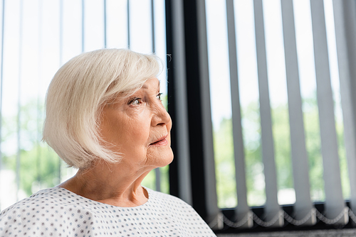 Senior woman looking away in hospital ward