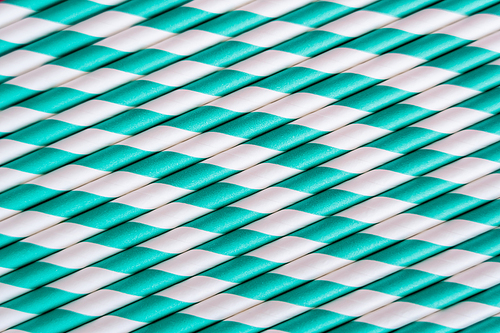 top view of striped blue and white straws as backdrop