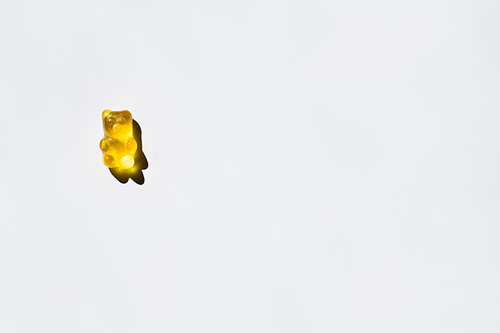 Top view of yellow gummy bear on white background
