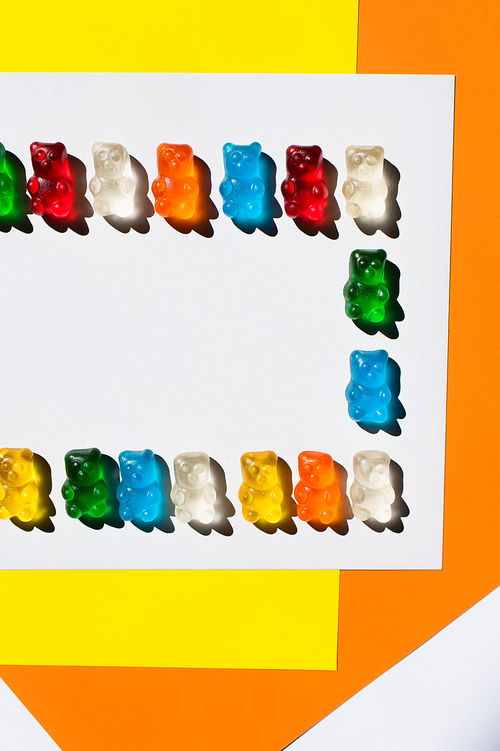 Flay lay of delicious gummy bears on colorful background