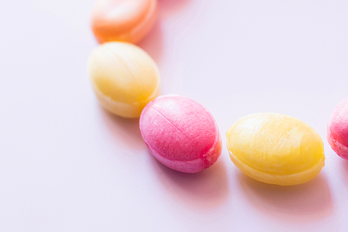 Close up view of colorful candies on white background