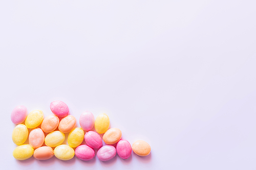 Top view of colorful sweets on white background with copy space