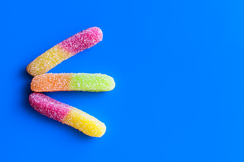Top view of jelly sweets on blue background