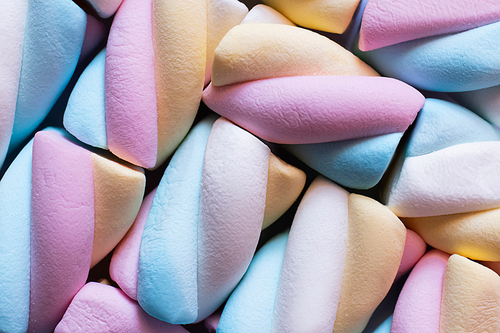 Close up view of colorful marshmallows isolated on black