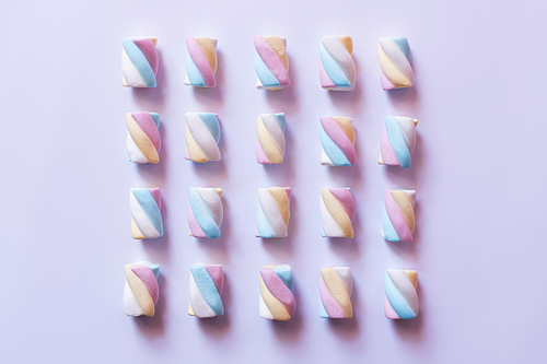 Flat lay with colorful marshmallows on white surface