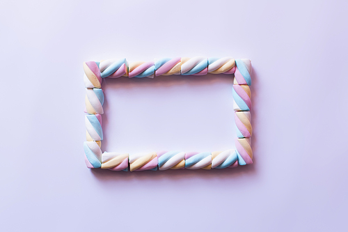 Flat lay with frame from marshmallows on white background
