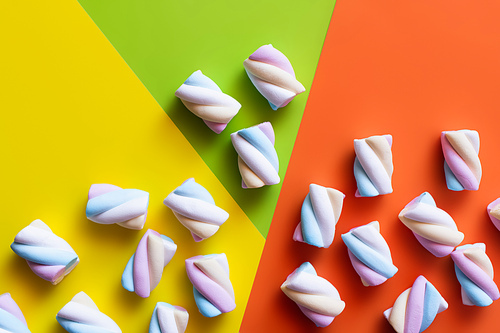 Top view of fluffy marshmallows on colorful background