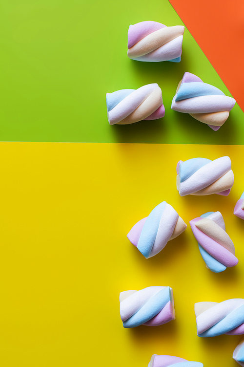 Top view of soft marshmallows on colorful background
