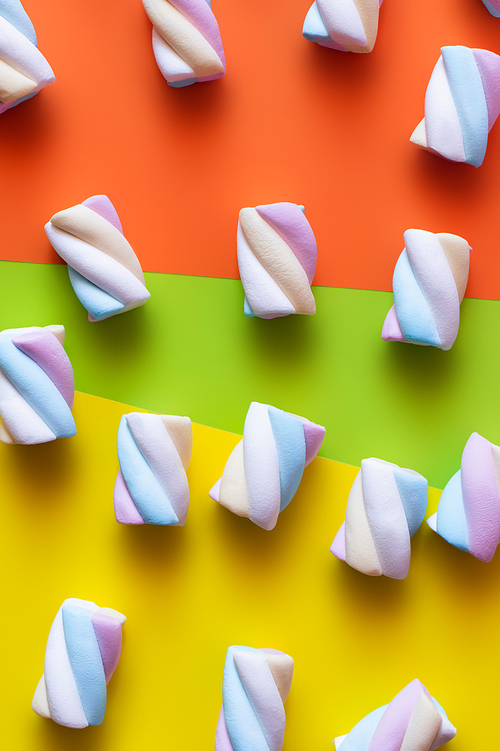 Top view of sweet marshmallows on colorful surface