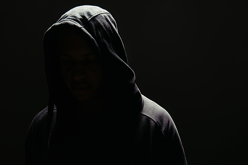 Silhouette of hooligan in hoodie isolated on black