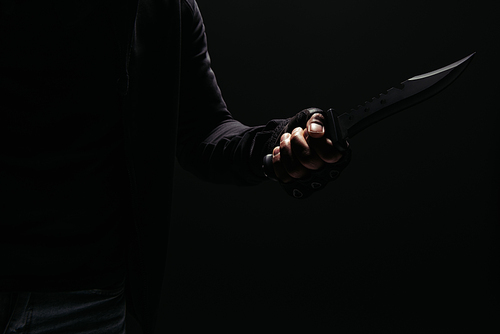 Cropped view of african american robber holding knife isolated on black