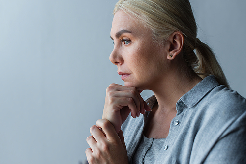 portrait of blonde woman with blue eyes worried because of menopause