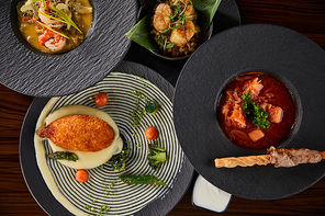 top view of delicious restaurant dishes on wooden table