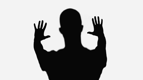 black silhouette of man showing stop gesture isolated on white