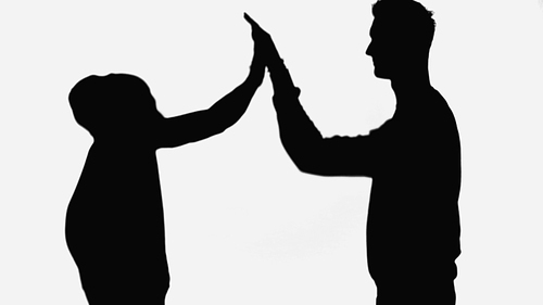 black silhouettes of friends giving high five isolated on white