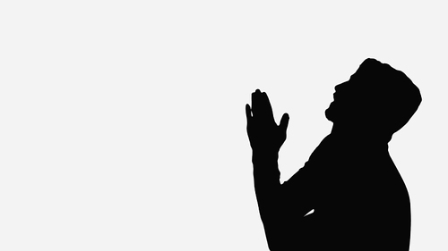 black shadow of man with praying hands isolated on white