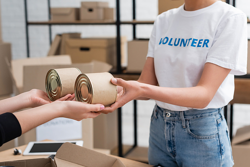 cropped view of african american volunteer handing out humanitarian help