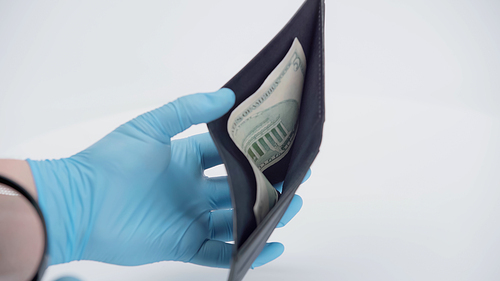 cropped view of person in latex gloves showing wallet with dollar banknote on white background