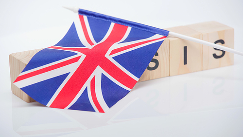 British flag on wooden cubes with crisis lettering on white background