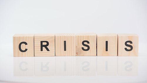 wooden cubes with crisis lettering on white background