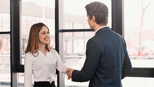 happy woman shaking hands with employer after job interview