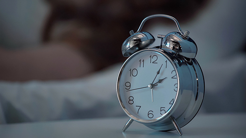 Alarm clock on bedside table at night