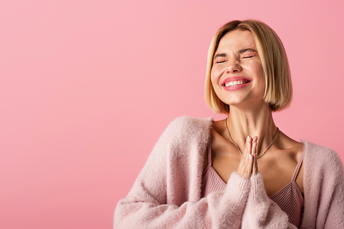 happy young woman with closed eyes smiling isolated on pink