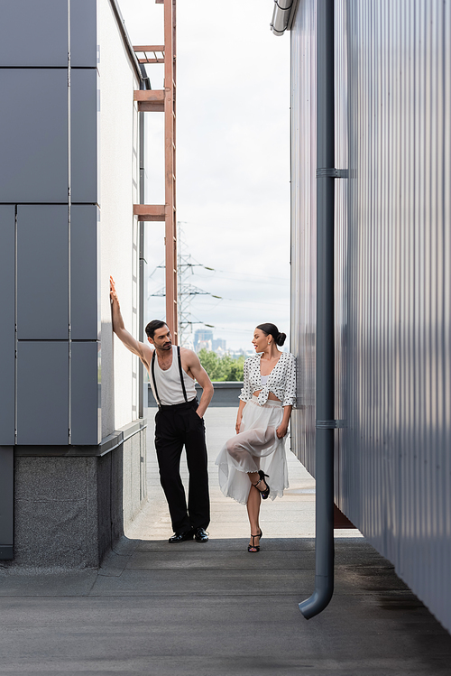 Professional dancers standing on rooftop of building at daytime