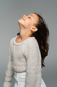 brunette girl in knitted sweater posing with raised head isolated on grey