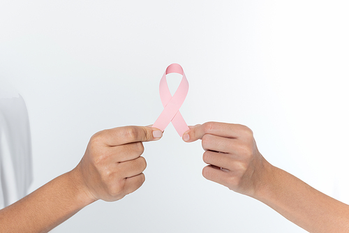 Cropped view of women holding pink ribbon of breast cancer awareness isolated on grey