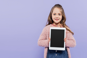 happy girl holding digital tablet with blank screen isolated on purple