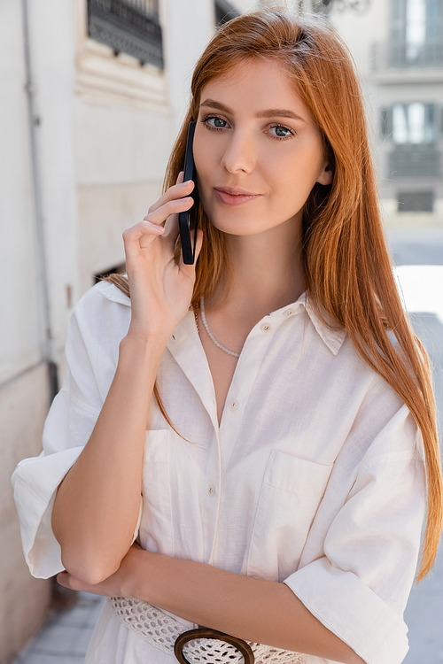 portrait of redhead woman talking on mobile phone in valencia