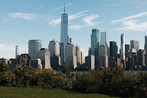 financial center of Manhattan with One World Trade Center near Hudson river and park in New York City